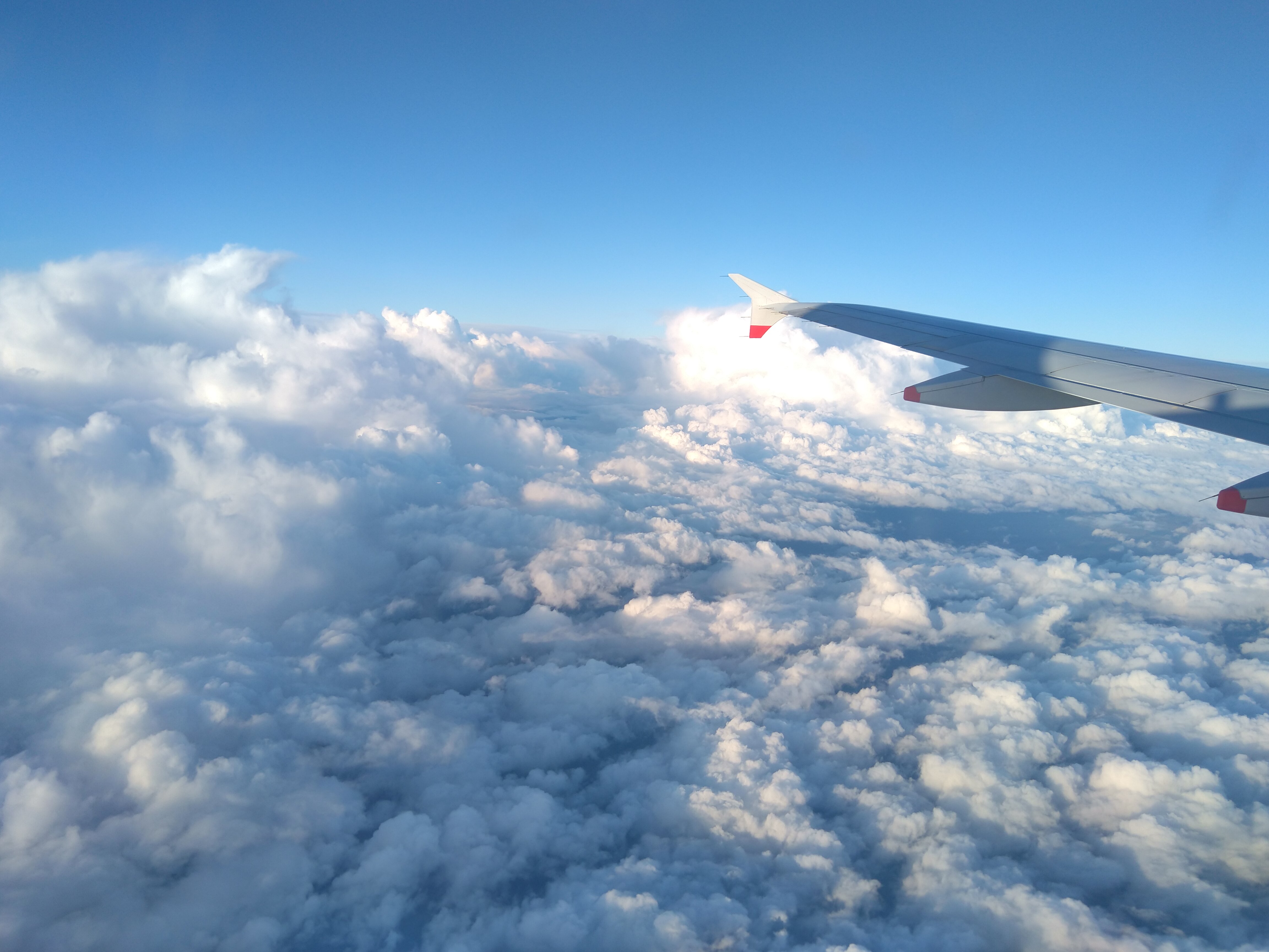 White clouds under airplane wings